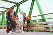 © Lomb - a group of multiracial young people walking together crossing a bridge on a weekend day - lifestyle concept of friendship, brotherhood between different cultures, integration and internationalization