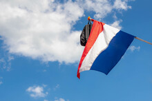 Official Netherlands Flag With A School Bag Hanging Outside The House Along The Street With Blue Sky, A Tradition Way In Holland When A Student Celebrate Their Graduates Or Geslaagd In Dutch Word.