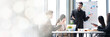 © SKW - An Asian businessman is presenting his company performance report to his boss or group of male and female colleagues with confidence and professionalism web banner with copy space on left