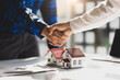 © Wasan - Real estate agents shake hands after the signing of the contract agreement is complete.