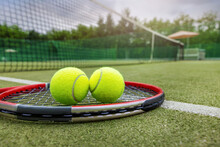 Tennis Racket And Balls On Synthetic Grass Outdoor Court
