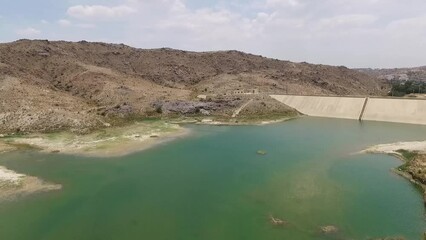 Sticker - The lake of the Wadi Al-Janabin Dam near the city of Baljurashi in Saudi Arabia, picturesque nature