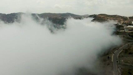 Wall Mural - Mesmerizing drone view of a beautiful mountainous valley and city in northern Saudi Arabia