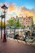 Amsterdam. Holland. Downtown of Amsterdam. Traditional houses and bridges of Amsterdam. A colorful sundown time.