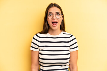 Wall Mural - young adult pretty woman feeling terrified and shocked, with mouth wide open in surprise