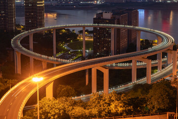 Wall Mural - At night, the circular overpass and the urban skyline are in Chongqing, China