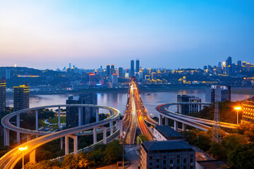 Wall Mural - At night, the circular overpass and the urban skyline are in Chongqing, China