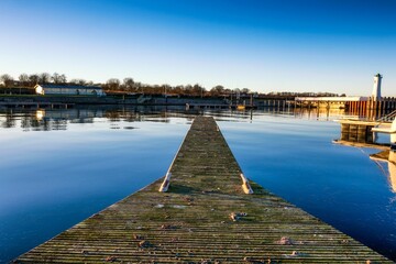 Sticker - Beautiful view of a wooden pier going to the blue lake