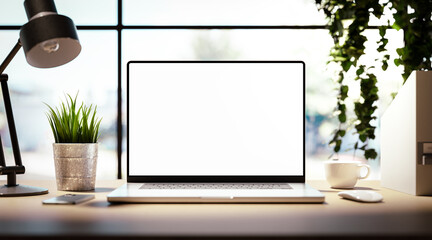 Wall Mural - laptop with blank screen on table in bright livingroom - home office background