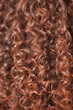 Curly woman hair. Afro hairstyle background. Beautiful brown long wavy haircut, close up.