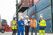 © narong - Group of professional engineer, worker or technician walk and discuss together about work in cargo container workplace area with crane and stack of container tank on background.