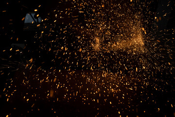 Lights in dark. Sparks from sawing metal. Industrial background.