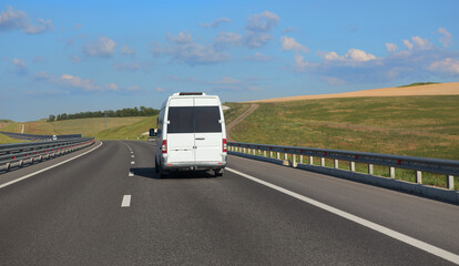 Wall Mural - minibus moves along a suburban highway