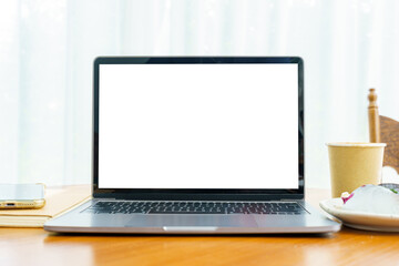 Wall Mural - Mockup of laptop computer with empty screen with notebook,Hot coffee in cup made of paper and Blueberry Cake and smartphone on table side the window in the coffee shop at the cafe,White screen