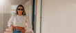 © carballo - latin girl with sunglasses smiling with copy-space