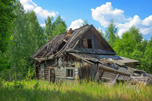 Abandoned Wooden Old House, Desolation And Ruin, An Old Village House Among Trees In  Fores
