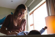 © Wavebreak Media - Caucasian mid adult mother lying newborn baby on nappy changing table by window at home, copy space