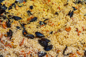 Close up of seafood paella for sale at the international street food festival. Background