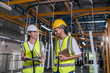 © Kawee - Asian male and female industrial worker working in manufacturing plant