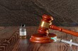 Judges hammer, syringe and vaccine bottle on a wooden background. Concept for a medical judgment