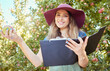 © Jade M/peopleimages.com - Woman holding an apple and a clipboard on a sustainable orchard farm in summer. Happy farmer doing stock taking and checking a checklist while harvesting fresh organic green and red fruit from trees