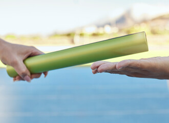 Sticker - Closeup of two athletes passing a baton during a relay race on a running track. Active fit athlete handing the baton over during a relay race to a team member while running in an sport competition