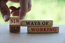 Hand Turning Wooden Cube Text From OLD To New Ways Of Working. New Normal Concept