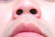 young man's nose His nostrils are hairy. . Health and medical concepts