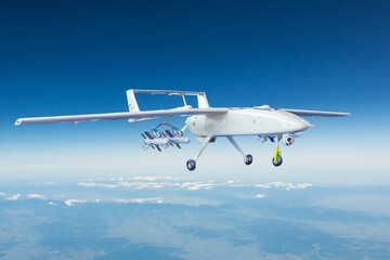 Military UAV airplane drone armed with rockets flies high in the sky over an unknown location.