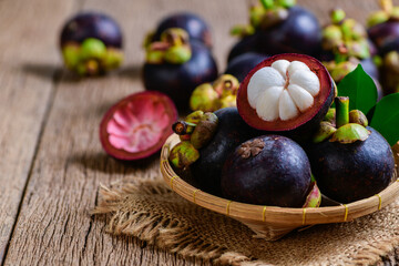 Wall Mural - Fresh Mangosteen in bamboo basket and on old wood baclground.