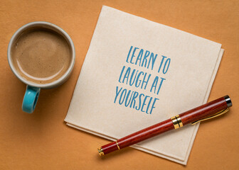 Wall Mural - learn to laugh at yourself inspirational note on a napkin with coffee, personal development concept