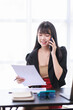 © David - Smile business woman, Young Asian businesswoman talking on the phone using a laptop computer at the office.