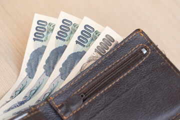 Japanese yen banknotes management for exchange and trading. Manage salaries, income, and expenses to be balanced. Financial, investment, and saving money after retirement concepts.