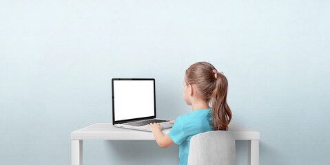 Canvas Print - young girl using laptop computer in living room. isolated laptop display for web page promotion. bac