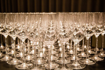 empty champagne glasses arranged in rows on catering service banquet