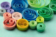 © killykoon - Paper quilling, or quilled paper. Spectrum of coiled paper strips in many colors. Background or cover for something creative or united in diversity. shallow depth of field.
