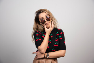 Young woman with glasses making playful faces