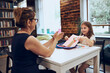 © Przemek Klos - Woman teaching schoolgirl during classes at primary school. Child doing work sitting at desk in afterschool club. Learning at primary school. Elementary education. Back to school