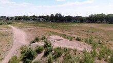 Drone Shot Of A Undeveloped Vacant Lot On The Edge Of A Dutch City, With A Skyline In The Background