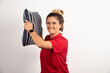 Woman in red shirt hugging a pillow on white background