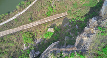 Aerial Photography From A Drone. Top View Of The Railway Tracks Leading Into A Tunnel In The Mountain, The Path Ends Abruptly, Perspective And A New View.