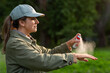 © Syda Productions - health care, protection and people concept - woman spraying insect repellent or bug spray to her hand at park