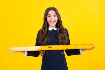 Excited face. Back to school. Teenager school girl on yellow background. Amazed schoolgirl with school supplies.