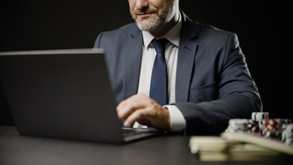 Close-up of businessman making online bet on laptop, gambling, game of luck