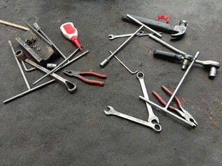 Top view of different working tools on the garage floor