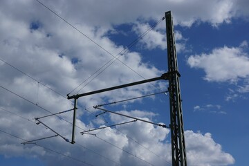 Sticker - Silhouette of overhead line mast with boom against blue and white sky