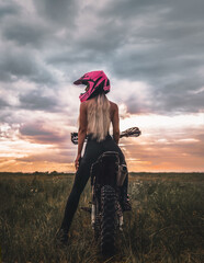 a girl on a motorcycle. a woman on a cross-country moto. blonde on a motorbike