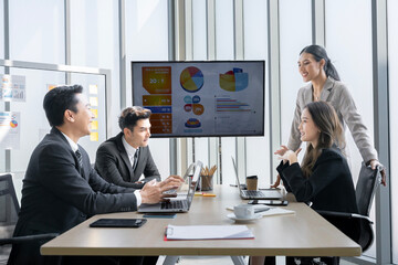 A group of young Asian businessmen Talking and planning work happily and have fun. at the company's office