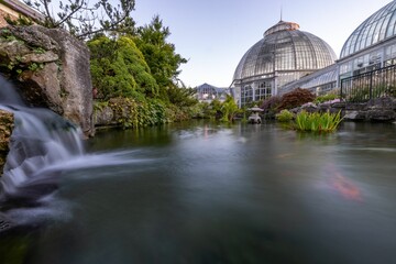 Poster - Waterfall and lake in long exposure with Anna Scripps Whitcomb Conservatory in the background.