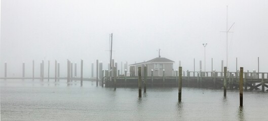 Wall Mural - beautiful shot of a long wooden pier in cape cod hyannis ma dock in fog